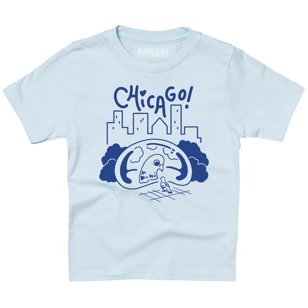 Youth-sized pastel blue t-shirt with royal blue ink depicting a pigeon looking at its reflection in Cloud Gate with a skyline in the background and "Chicago" above.