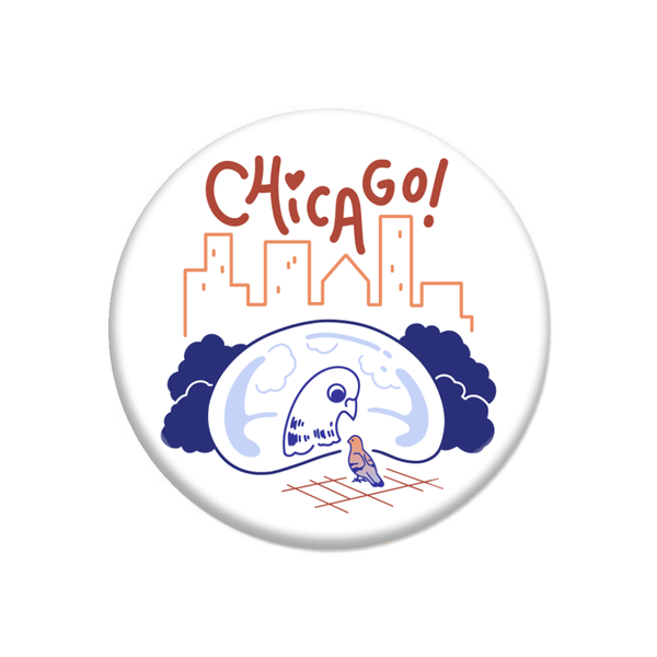 A white circular button with royal blue and red print depicting a pigeon looking at its reflection in Cloud Gate with a skyline in the background and 
