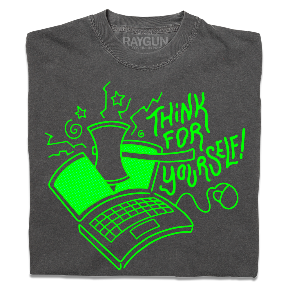 A folded heavyweight grey t-shirt with a bright green ink illustration of a laptop being cut in half by an axe and text to the right that says, "Think For Yourself!"