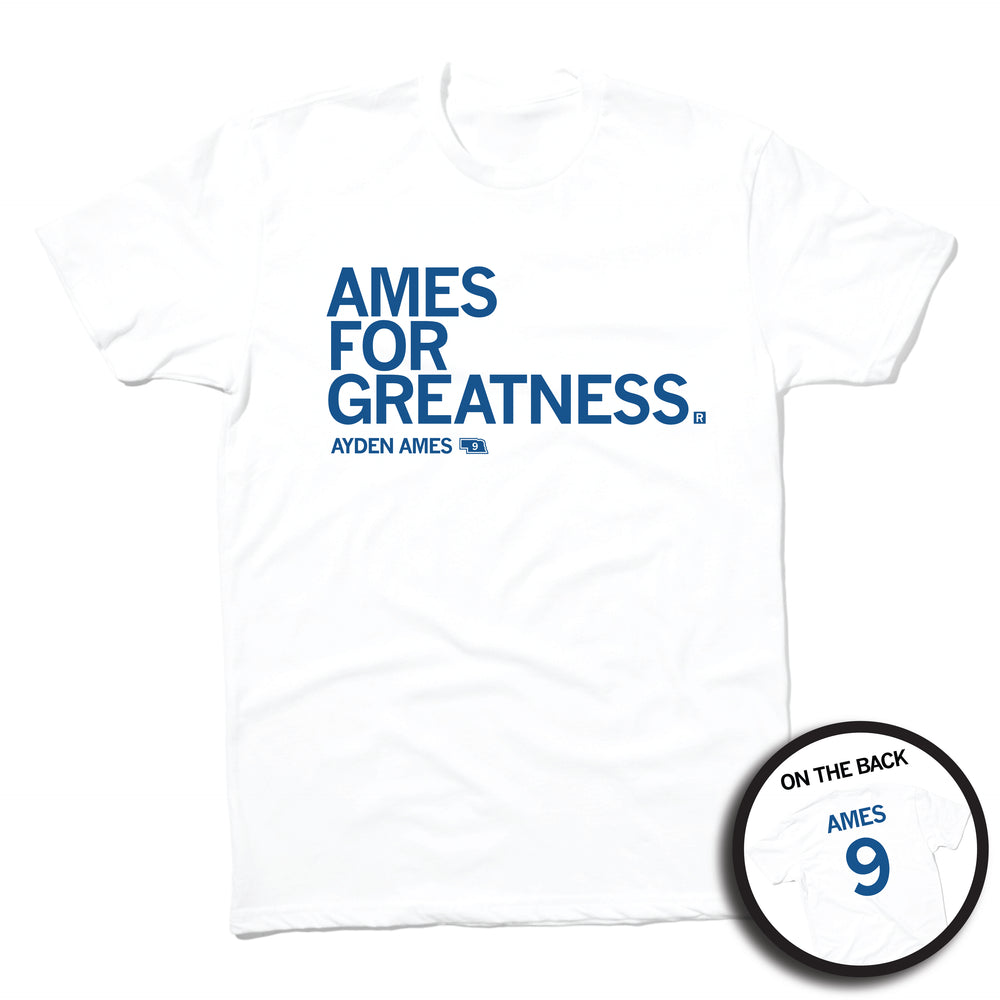 Short sleeve white t-shirt with left-aligned royal blue text that says, "AMES FOR GREATNESS" with "AYDEN AMES" in smaller text below. To the right of her name is an outline of Nebraska with the number "9" in its center. A circular picture to the bottom right shows the back of the shirt. The back is printed like a jersey with "AMES" above a large 9.