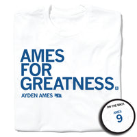 A folded white t-shirt with left-aligned royal blue text that says, "AMES FOR GREATNESS" with "AYDEN AMES" in smaller text below. To the right of her name is an outline of Nebraska with the number "9" in its center. A circular picture to the bottom right shows the back of the shirt. The back is printed like a jersey with "AMES" above a large 9.