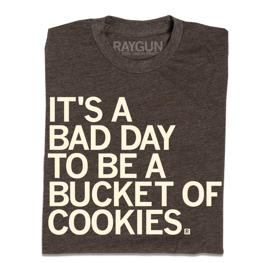 A dark heather brown T-shirt with the text ITS A BAD DAY TO BE A BUCKET OF COOKIES. printed in white.