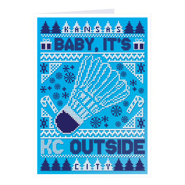 Holiday greeting card with a pixelated blue and white knit pattern featuring a shuttlecock in the center and the text Kansas City, Baby, It’s Cold Outside. This RAYGUN design is made in the USA.