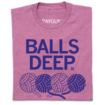 Heathered cassis purple RAYGUN t-shirt with the text BALLS DEEP in blue above an illustration of four balls of yarn.