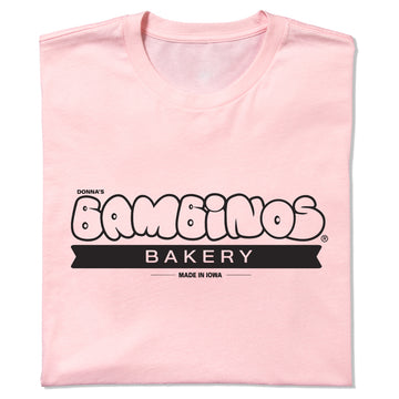 Light pink Donna’s Bambinos Bakery t-shirt with a black logo that reads Made in Iowa.