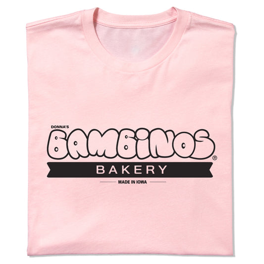 Light pink Donna’s Bambinos Bakery t-shirt with a black logo that reads Made in Iowa.