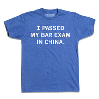 A short-sleeve heather blue t-shirt with white text that reads "I passed my bar exam in China." in all caps.