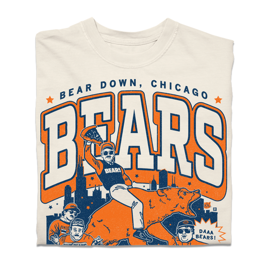 A Comfort Colors Ivory shirt with a large orange & navy graphic. of the SNL superfans riding a bear in front of the Chicago skyline. 