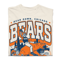 A Comfort Colors Ivory shirt with a large orange & navy graphic. of the SNL superfans riding a bear in front of the Chicago skyline. 