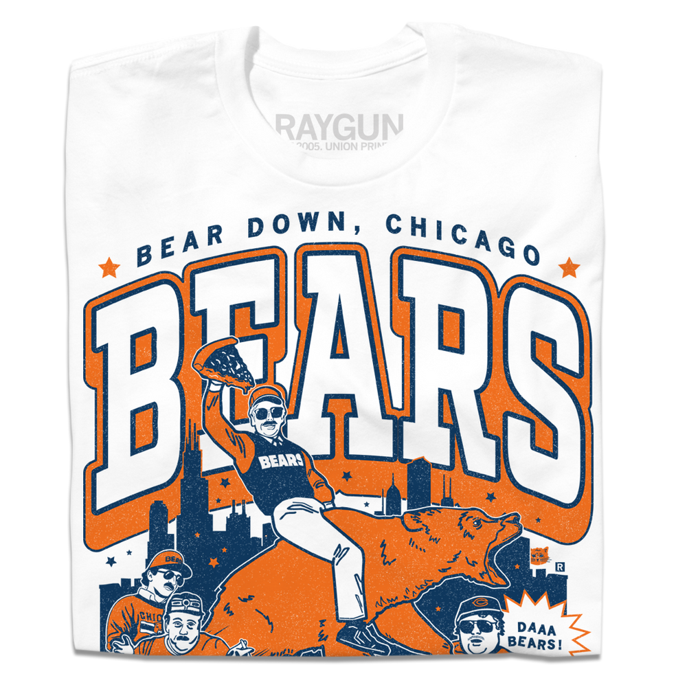 White t-shirt with a large orange & navy graphic. of the SNL superfans riding a bear in front of the Chicago skyline. 
