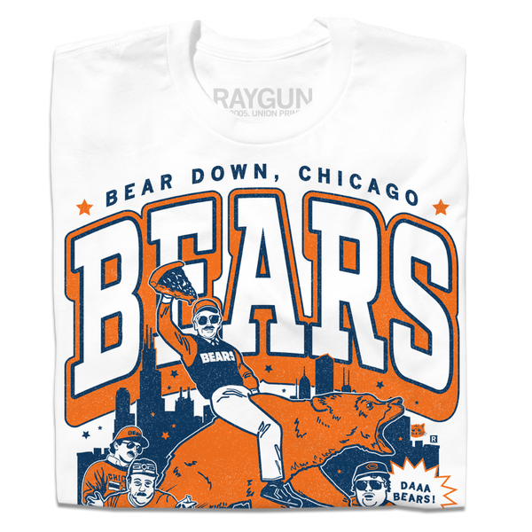 White t-shirt with a large orange & navy graphic. of the SNL superfans riding a bear in front of the Chicago skyline. 
