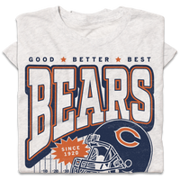 A folded heather white t-shirt with a vintage style print in orange and navy ink. Text from top to bottom reads "Good, Better, Best. Bears. Since 1920. Chicago. Pope Approved." There's a football helmet over a football field in the center.