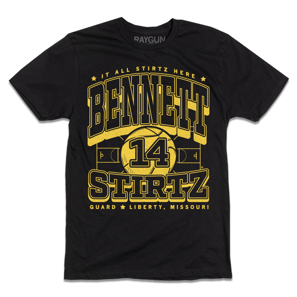 Black tee with yellow ink that reads "It all Stirtz here. Bennet Stirtz. Guard. Liberty, Missouri" over an illustration of a basketball court with a giant basketball in the center and the number 14.