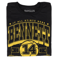 Black t-shirt with gold ink that reads "It all Stirtz here. Bennet Stirtz. Guard. Liberty, Missouri" over an illustration of a basketball court with a giant basketball in the center and the number 14.