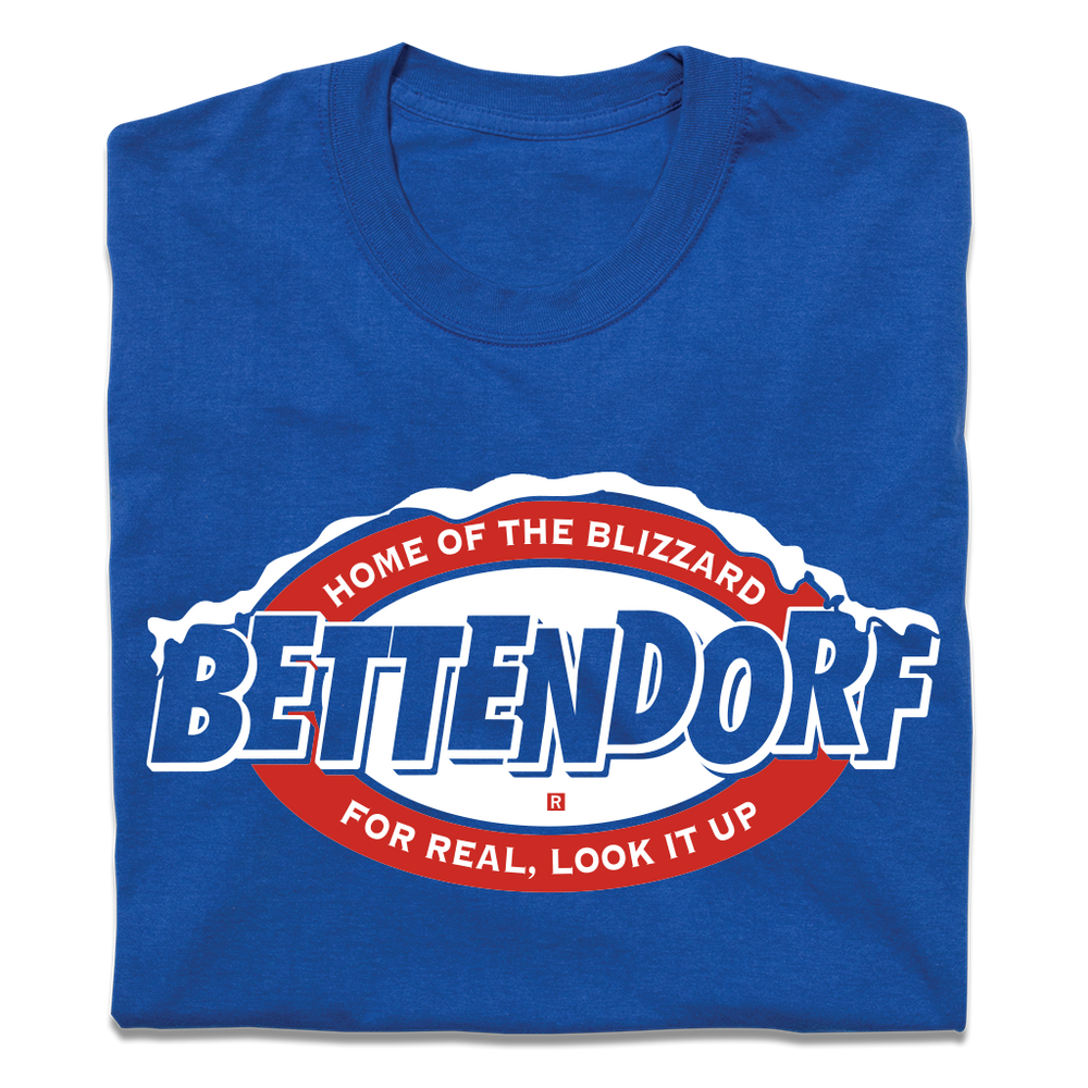 A folded royal blue t-shirt with red and white in that says, "Bettendorf: Home of the Blizzard. For real, look it up."