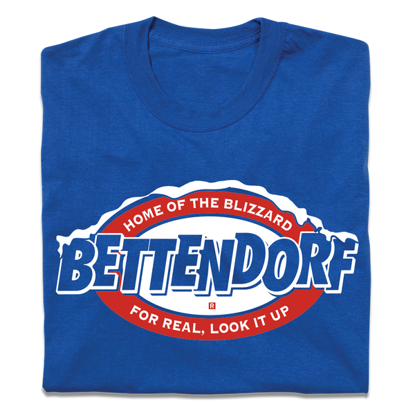 A folded royal blue t-shirt with red and white in that says, 