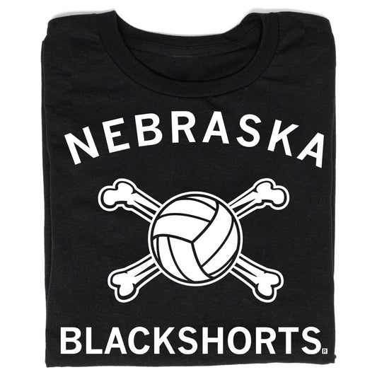 Black t-shirt with white text reading NEBRASKA above a volleyball crossed with two bones, and BLACKSHORTS below.