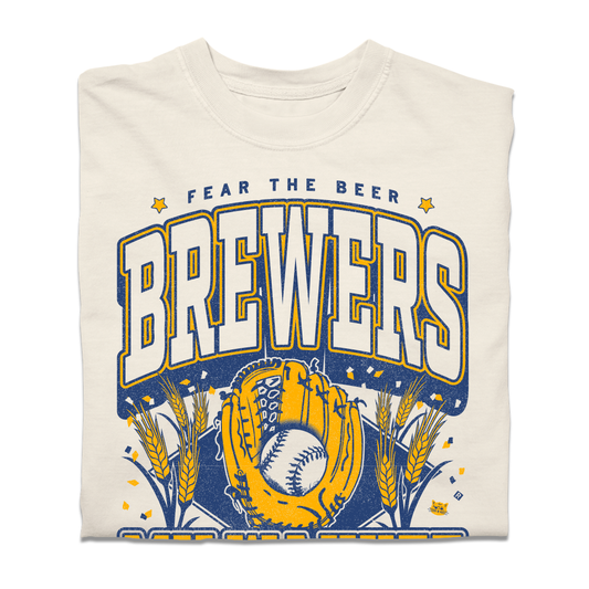 A heavyweight off-white t-shirt with gold and blue ink that reads "Fear the beer. Milwaukee Brewers. American Family Field." with a baseball landing in a mitt in the center and beer hops growing on either side.