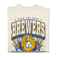 A heavyweight off-white t-shirt with gold and blue ink that reads "Fear the beer. Milwaukee Brewers. American Family Field." with a baseball landing in a mitt in the center and beer hops growing on either side.