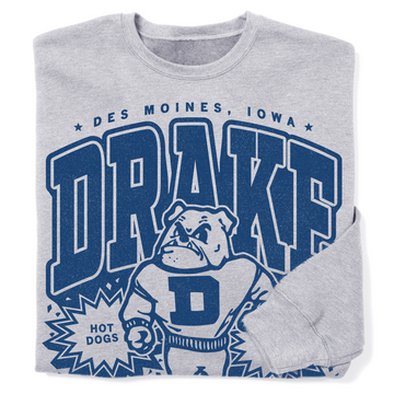 Athletic Heather gray crewneck sweatshirt featuring a blue graphic of the Drake University bulldog mascot and the text Des Moines, Iowa, Drake, and Hot Dogs.