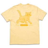 Heavyweight short-sleeve pastel yellow t-shirt with gold ink printed  a gradient depicting a cat made of butter. Text below says, "BUTTER CAT."