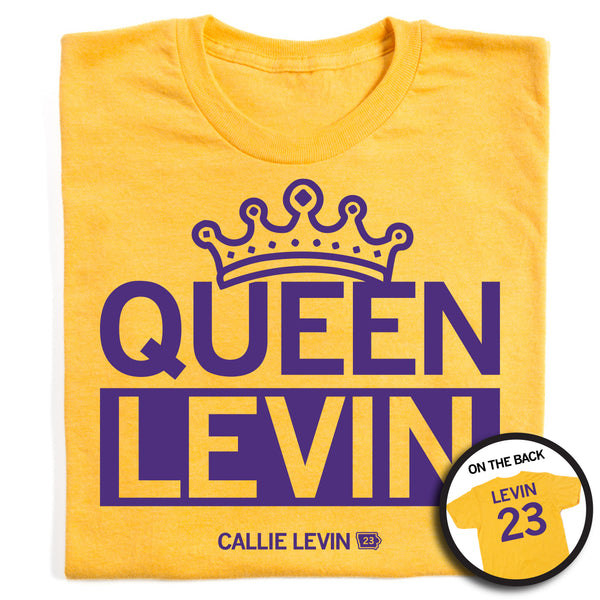 A folded heather gold t-shirt with purple ink print that says, 