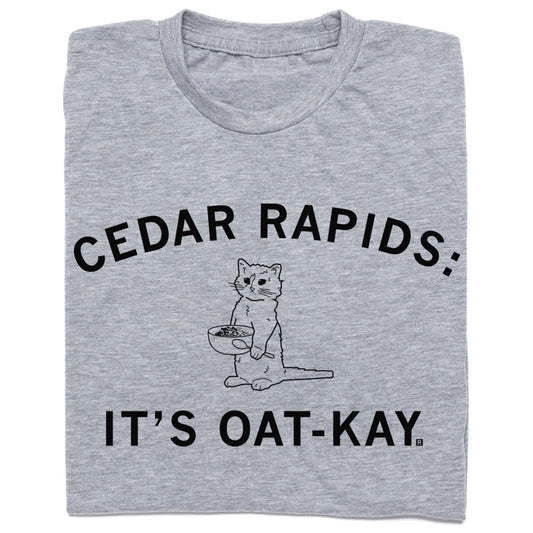 Heather gray t-shirt featuring a line drawing of a cat holding a bowl of oatmeal with the text CEDAR RAPIDS: ITS OAT-KAY.