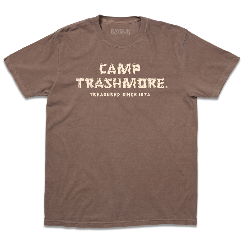 Comfort Colors brown heavyweight t-shirt with off-white ink that says, "Camp Trashmore. Treasured since 1974." printed in a font reminiscent of old summer camps.