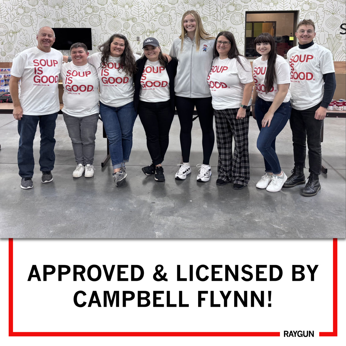 Eight people stand in a row, most wearing white RAYGUN t-shirts that say SOUP IS GOOD, with text below reading APPROVED & LICENSED BY CAMPBELL FLYNN!.
