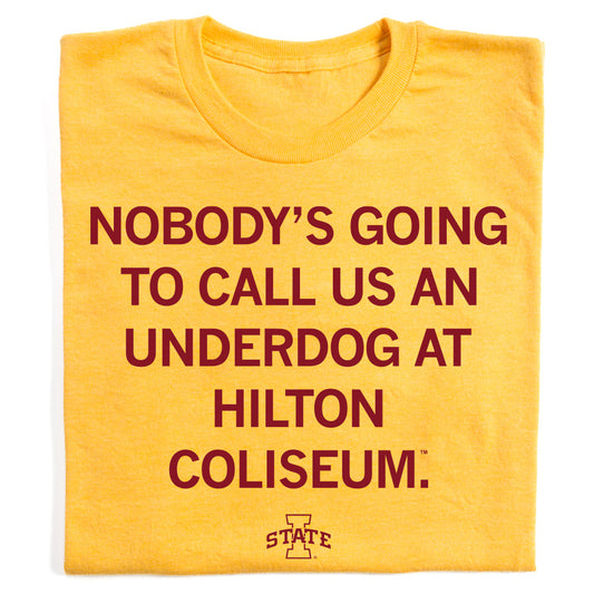 Heather mellow yellow t-shirt with the maroon text NOBODYS GOING TO CALL US AN UNDERDOG AT HILTON COLISEUM. and an Iowa State logo at the bottom.