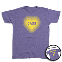 A heather purple t-shirt with gold ink. The front has a gold heart with the name Cass in the center and "Cassidy Hartman" at the bottom. The back reads "Hartman 2"