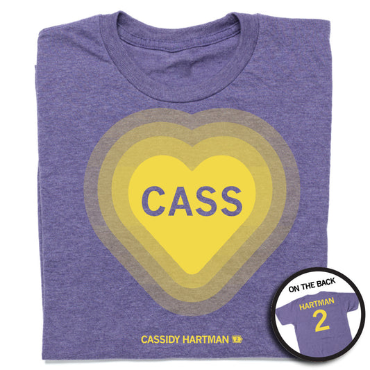 Heather Purple shirt with a gold heart in the center with the name Cass inside. Gold text underneath reads "Cassidy Hartman #2" and "Hartman 2" on the back.