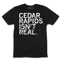 Black t-shirt with left-aligned white ink text printed in a distorted style that reads "Cedar Rapids Isn't Real"