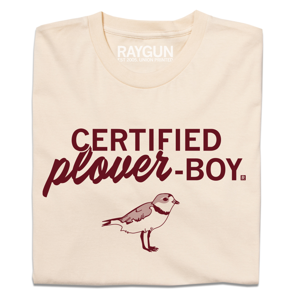 Folded off-white shirt with dark red print text that says, "CERTIFIED plover-BOY" above an illustration of a plover facing the right.