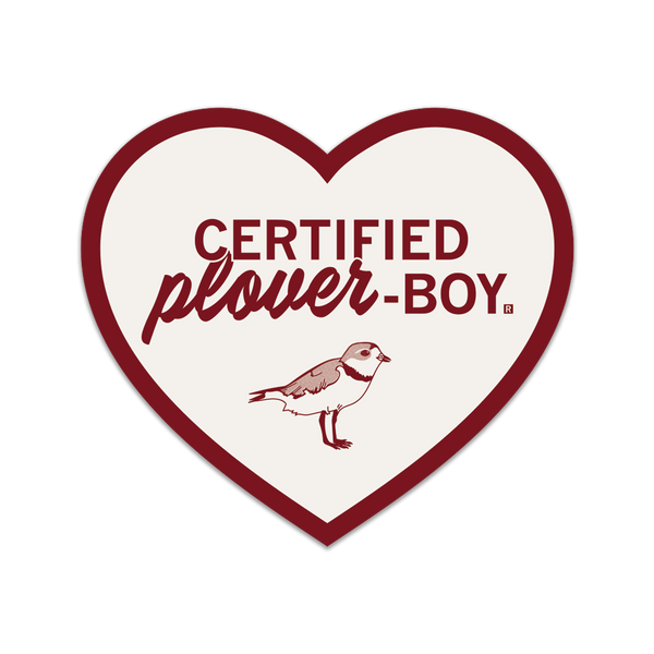 White heart-shaped die-cut sticker with a red border and red print that says, 