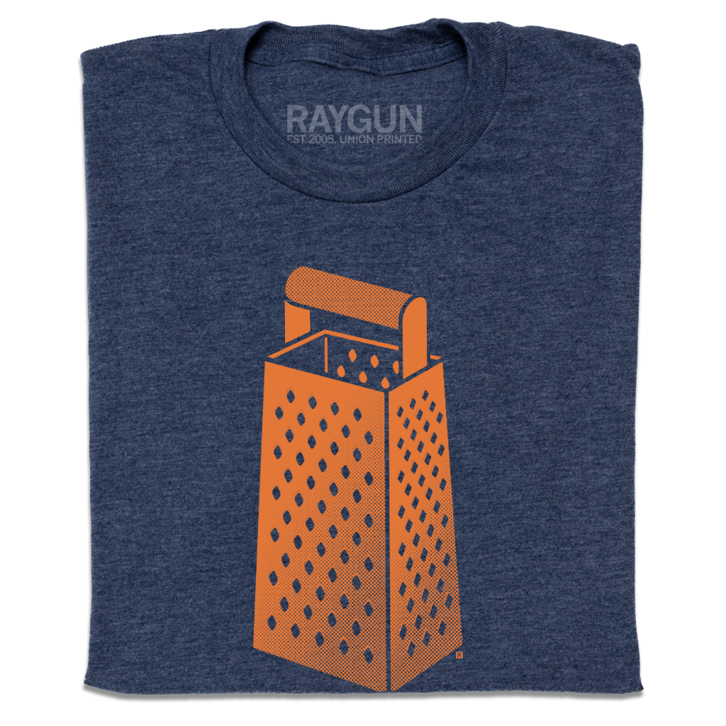 A folded heather navy t-shirt with an orange print of a cheese grater.