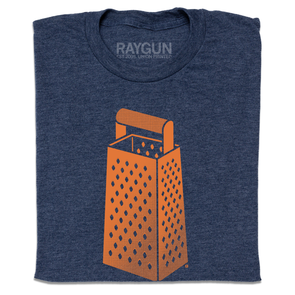 A folded heather navy t-shirt with an orange print of a cheese grater.