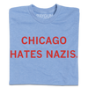 Light blue RAYGUN t-shirt featuring the red text CHICAGO HATES NAZIS printed on the chest.