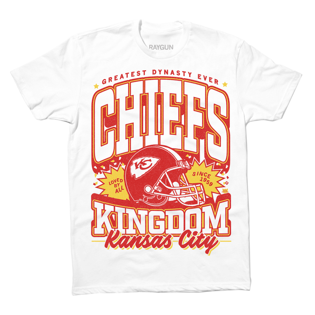 White RAYGUN t-shirt with a Kansas City Chiefs graphic featuring a football helmet and the text Greatest Dynasty Ever, Chiefs, Kingdom, and Kansas City.