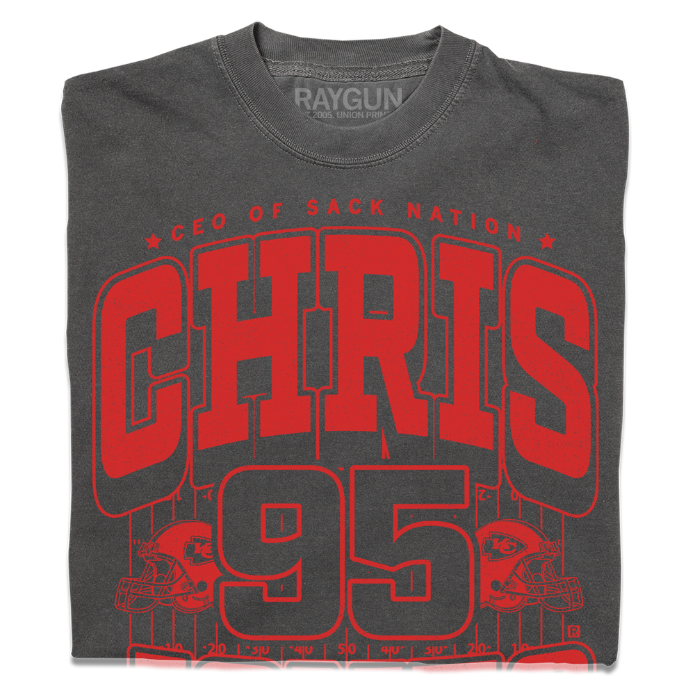 Folded grey comfort colors shirt with red ink that says, "CEO of Sack Nation, Chris Jones #95. Stone Cold Jones" over an illustration of a football field with a football helmet to either side.