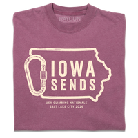 A folded Comfort Colors berry t-shirt with off white ink showing an outline of Iowa with it's western border being a carabiner. Large text inside the state outline says, "Iowa sends" and smaller text below reads "US Climbing Nationals. Salt Lake City 2026"