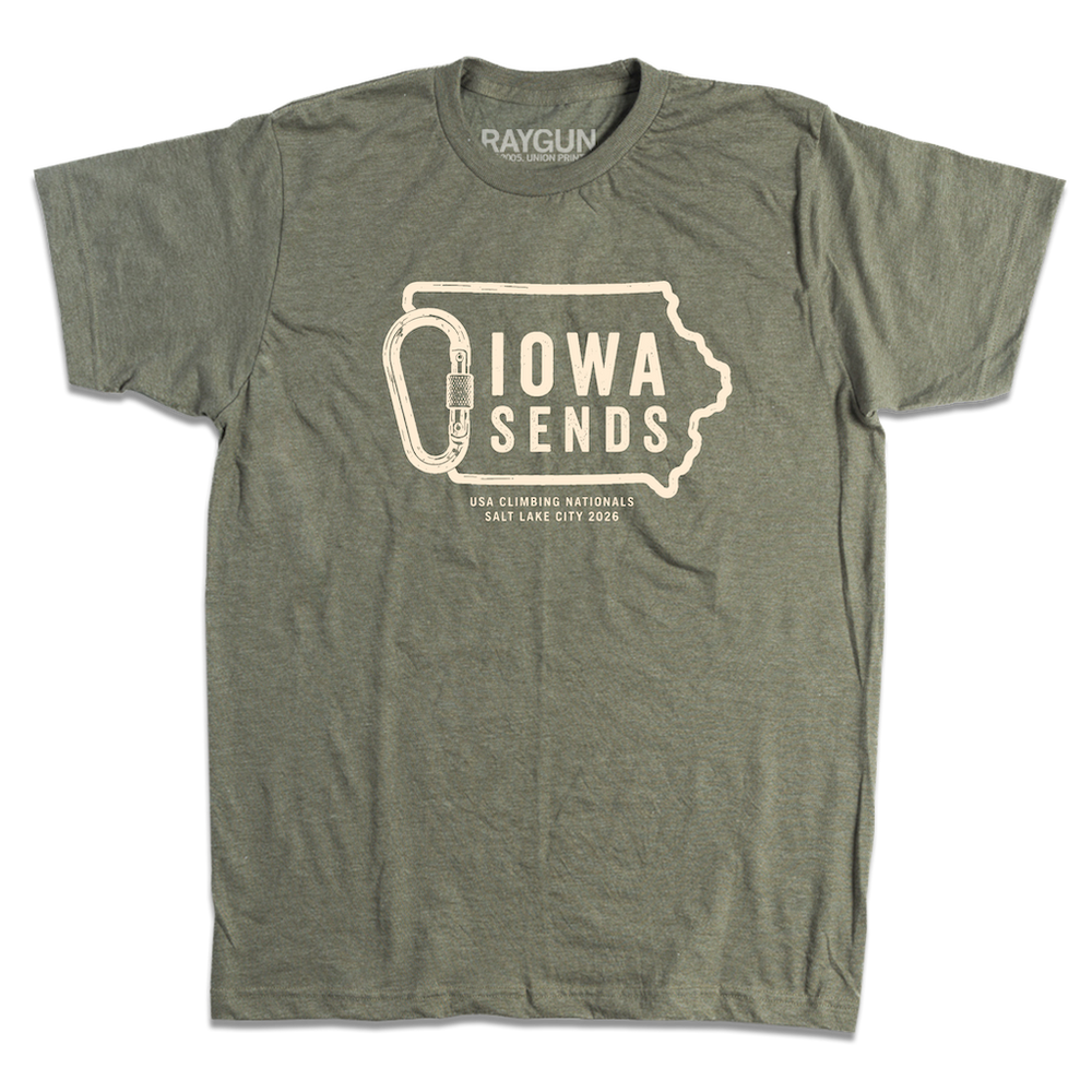 A heather olive green t-shirt with off white ink showing an outline of Iowa with it's western border being a carabiner. Large text inside the state outline says, "Iowa sends" and smaller text below reads "US Climbing Nationals. Salt Lake City 2026"