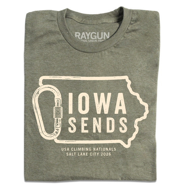 A folded heather military green t-shirt with off white ink showing an outline of Iowa with it's western border being a carabiner. Large text inside the state outline says, 