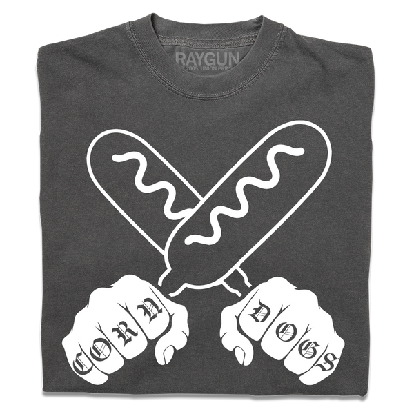 A folded grey t-shirt with a white print illustration of two hands holding corndogs in an X shape with knuckle tattoos that spell out 