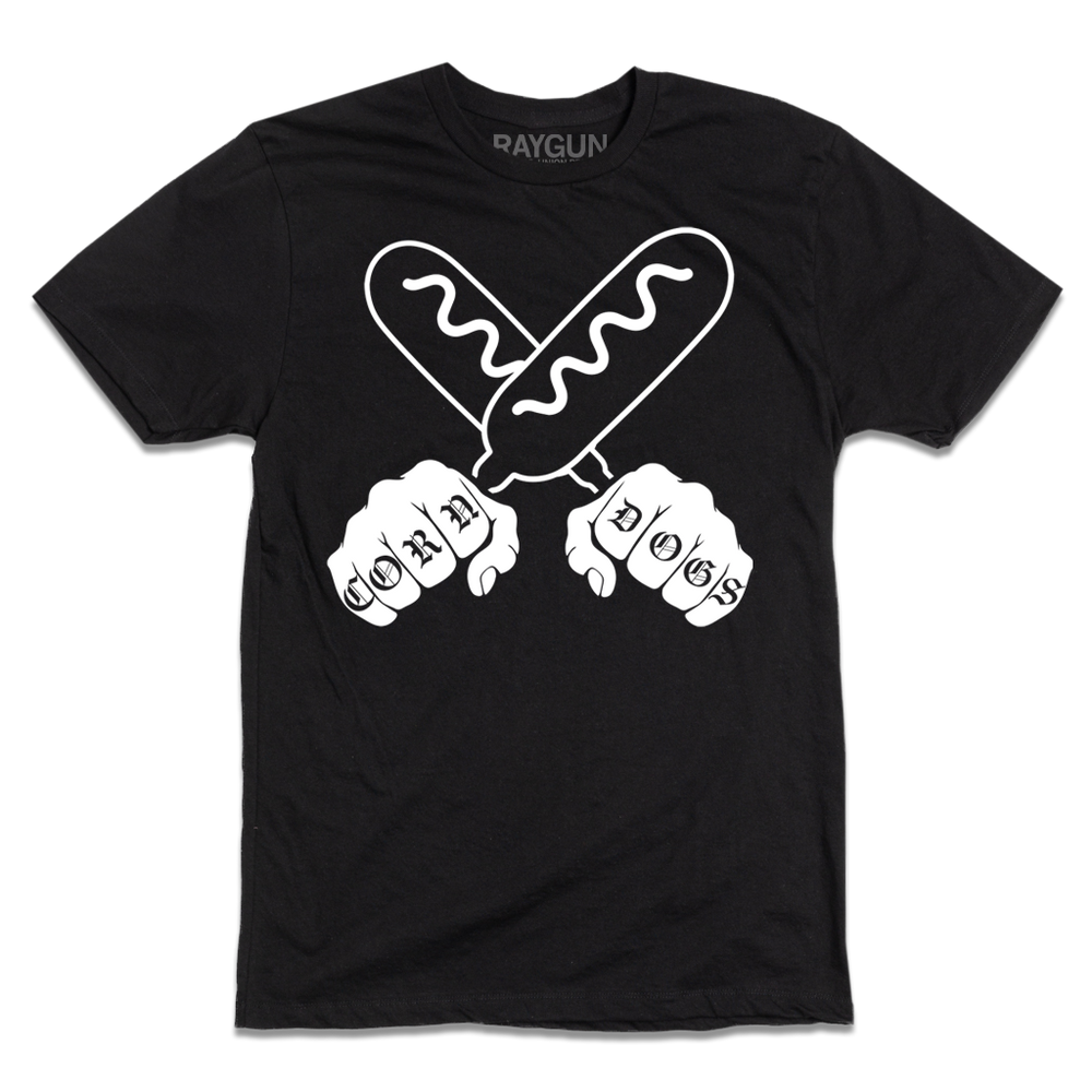 A short sleeve black t-shirt with a white print illustration of two hands holding corndogs in an X shape with knuckle tattoos that spell out "CORNDOGS."