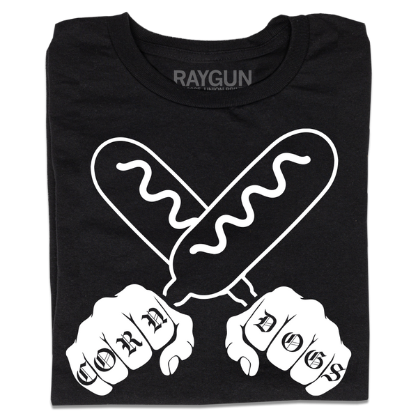 A folded black t-shirt with a white print illustration of two hands holding corndogs in an X shape with knuckle tattoos that spell out 