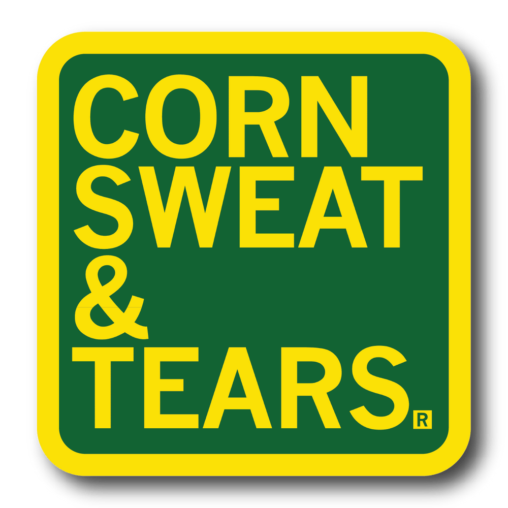 A square green sticker with rounded corners, a yellow border, and yellow text that says, "Corn Sweat & Tears"