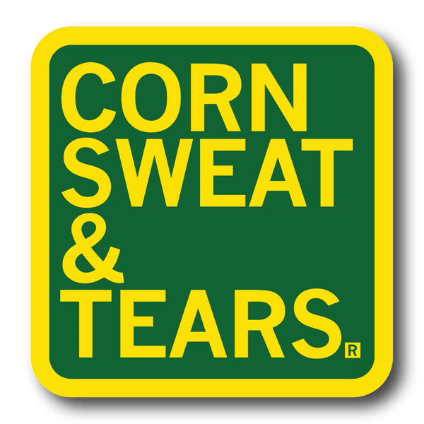A square green sticker with rounded corners, a yellow border, and yellow text that says, 