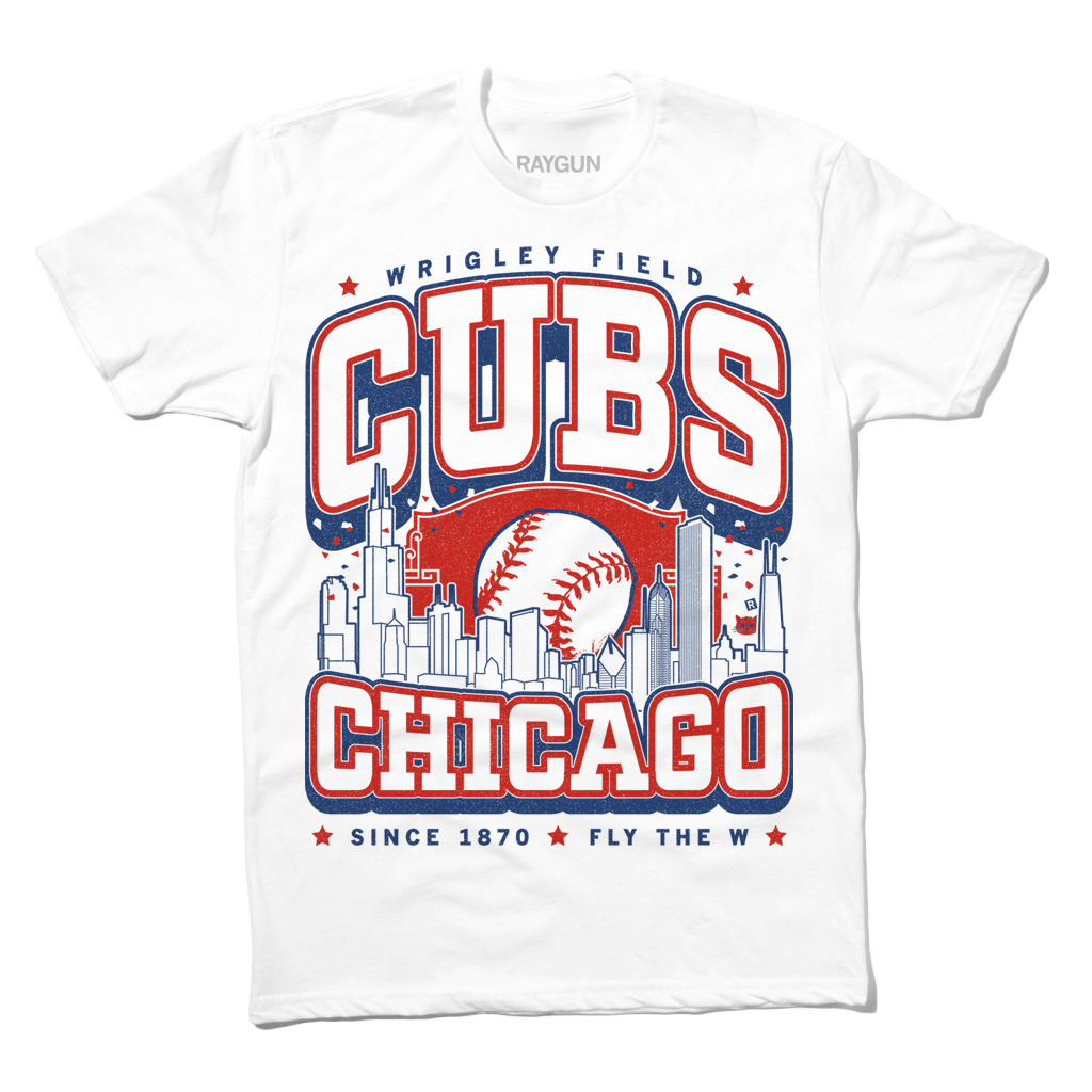 Short sleeve white t-shirt with red and blue print. The center depicts Chicago's skyline with a large baseball peaking out from behind it. Text from top to bottom reads "Wrigley Field. Cubs. Chicago. Since 1870. Fly The W."