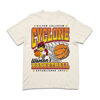 A off-white heavyweight shirt with black, red, orange, and gold ink. From top to bottom it reads "Hilton Coliseum. Cyclone Women's Basketball. Established 1973." With an illustration of Cy dribbling a basketball beside a giant basketball going through a hoop.